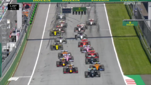 Pole sitter Verstappen gets off to a good start and angles his car ahead of the rest of the field for Turn 1.