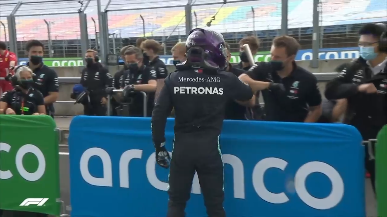 Lewis Hamilton, doing socially correct Covid-19 elbow bumping, celebrates with the Mercedes-AMG team.